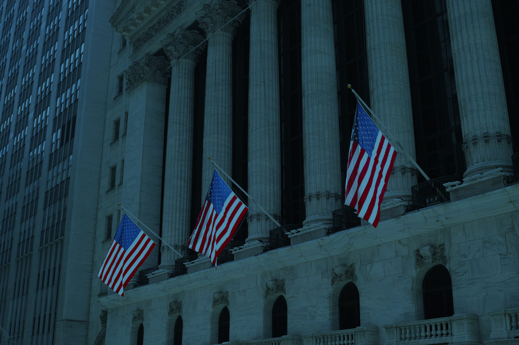 A row of American flags on a building